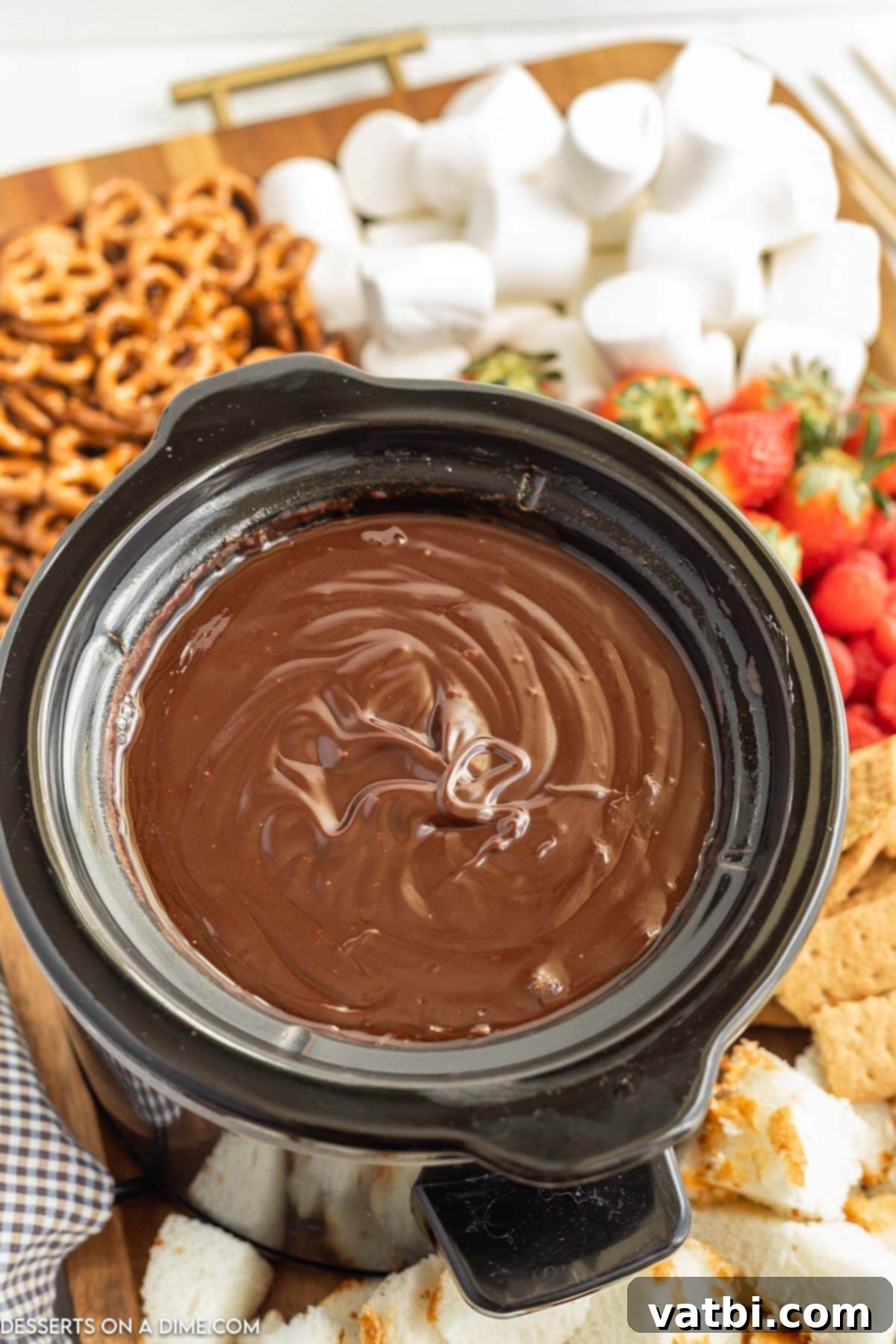 Rich chocolate fondue bubbling gently in a slow cooker, ready for dipping