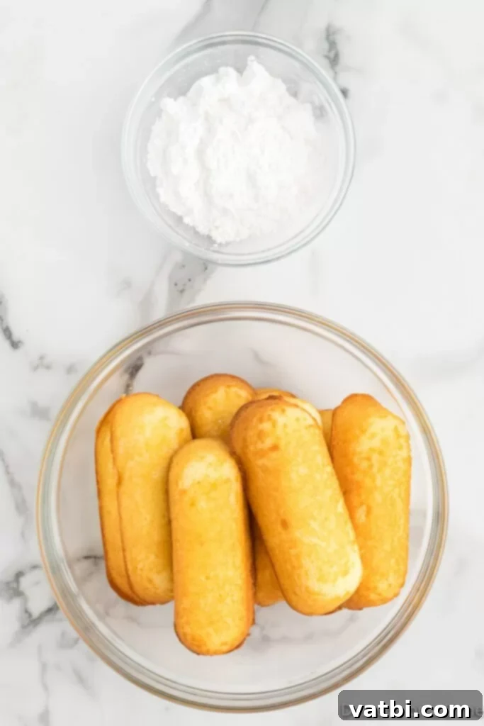 Golden Air Fried Twinkies 3 a bowl of twinkies and a bowl of powdered sugar