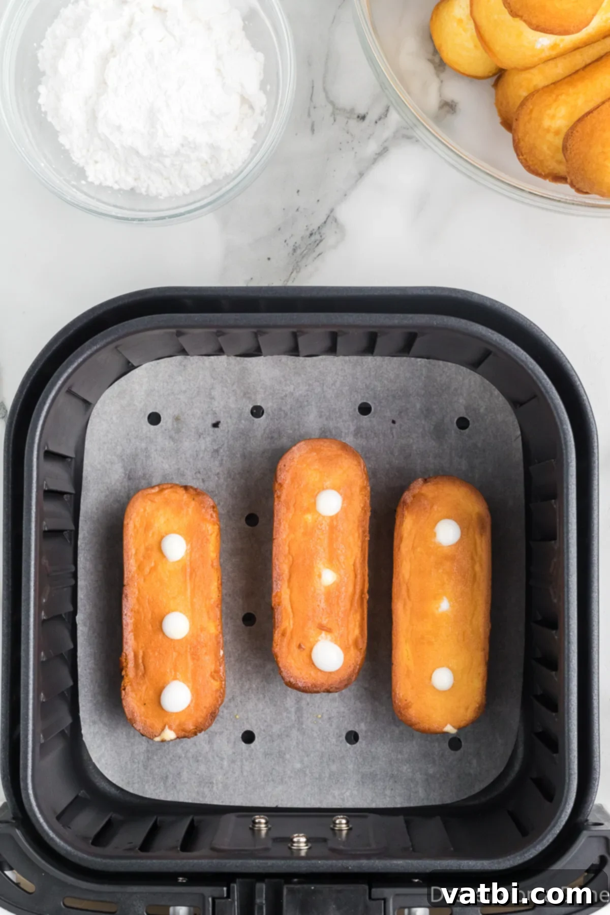 Golden Air Fried Twinkies 7 Twinkies in the air fryer golden brown.