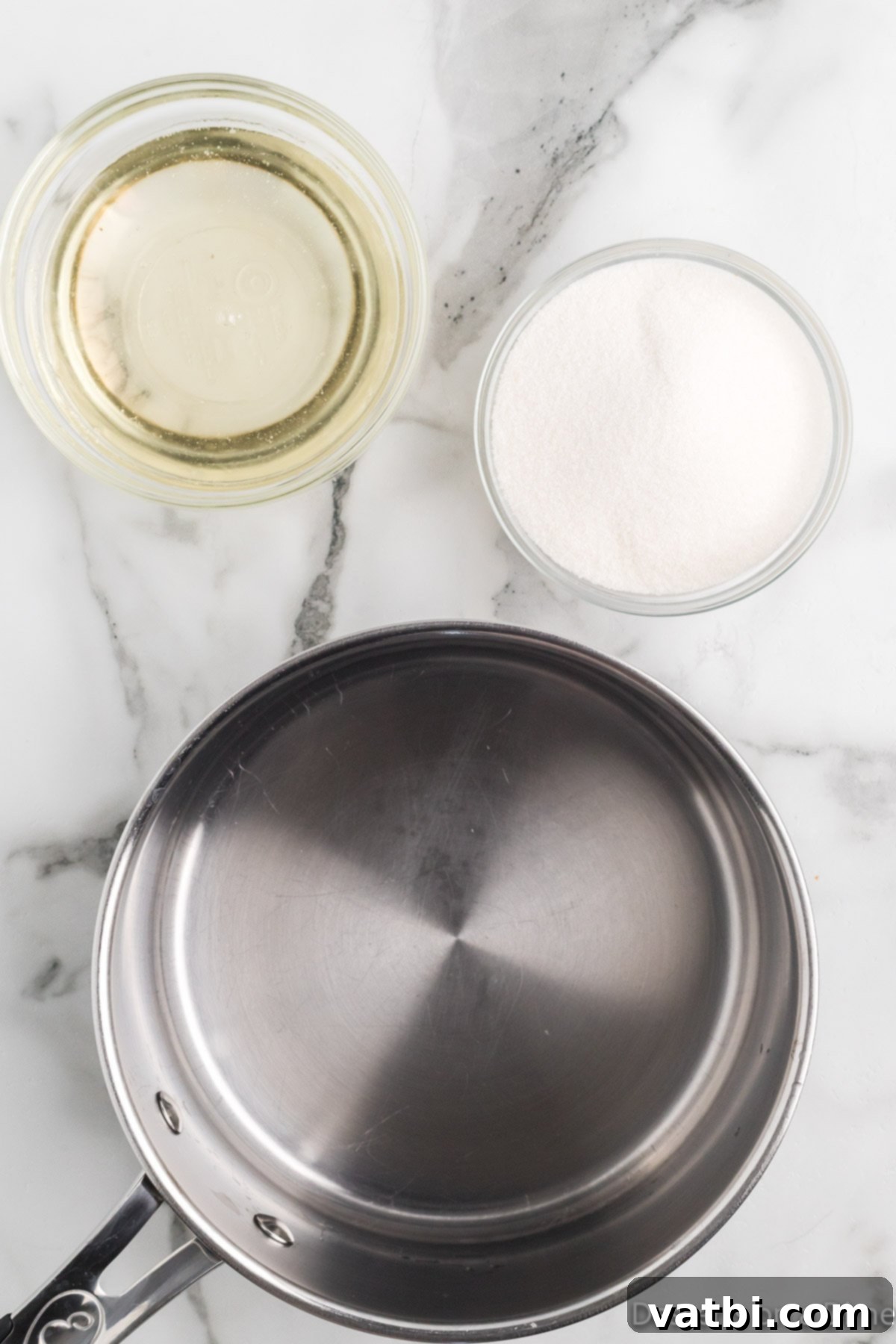 Cloud-Soft Homemade Marshmallow Fluff 2 A saucepan on a stovetop with water, sugar, and corn syrup measured out, ready to be combined.