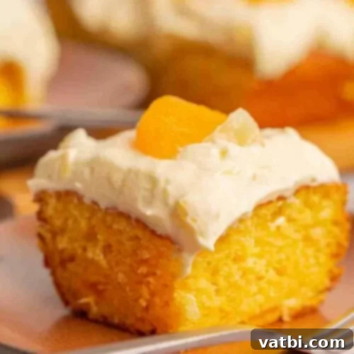 Zesty Delights 9 A delectable slice of Orange Pineapple Cake on a plate, ready to be enjoyed with a fork.