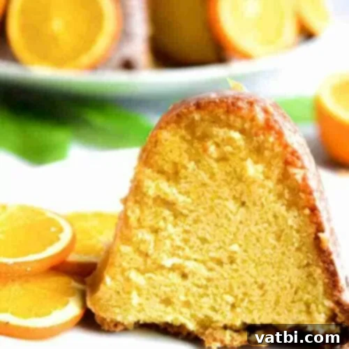 Zesty Delights 12 A slice of elegant Orange Bundt Cake with fresh orange slices, on a plate.