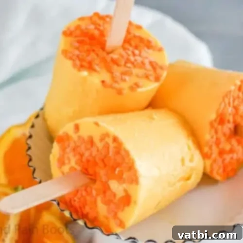 Zesty Delights 16 A group of Creamy Orange Dixie Cup Pops, ready to be enjoyed as a refreshing treat.