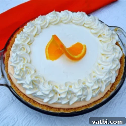 Zesty Delights 22 A beautiful No-Bake Orange Creamsicle Pie, topped with whipped cream and fresh orange slices.