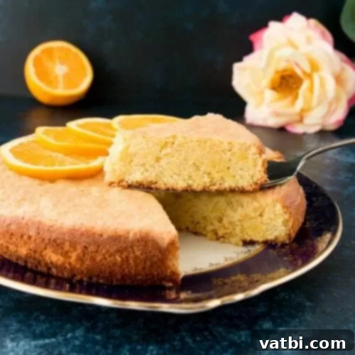 Zesty Delights 23 A slice of moist and delicious Orange Almond Cake on a plate with a fork.