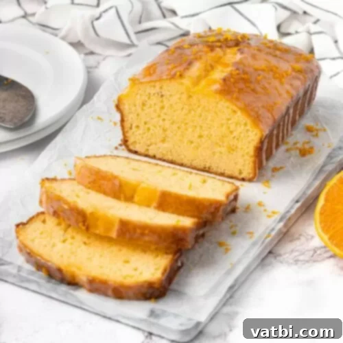 Zesty Delights 25 Slices of moist Orange Loaf Cake on a cutting board, ready to be served.