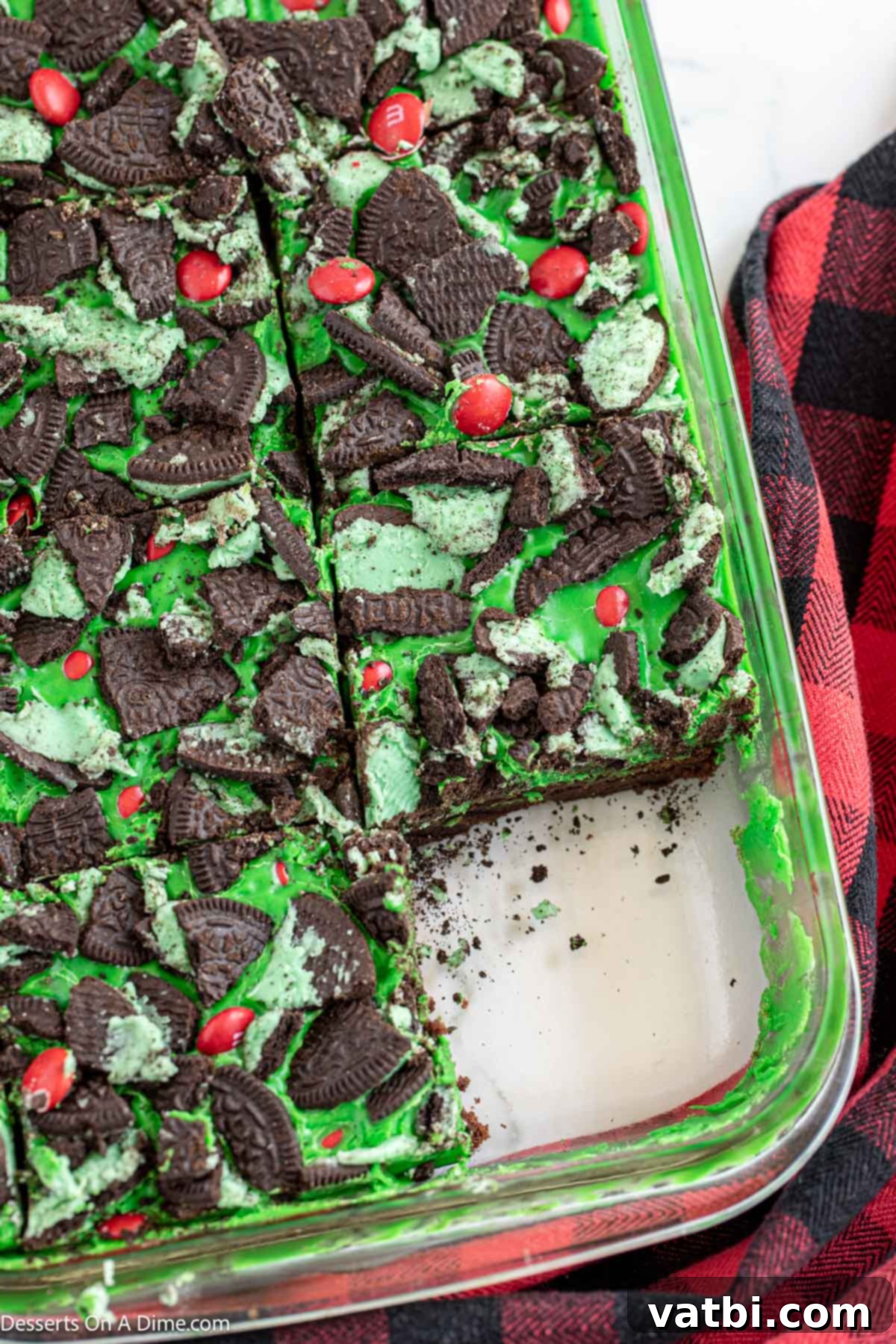 Grinch's Festive Fudgies 11 Grinch brownies, chilled and neatly cut into individual squares, ready to serve.