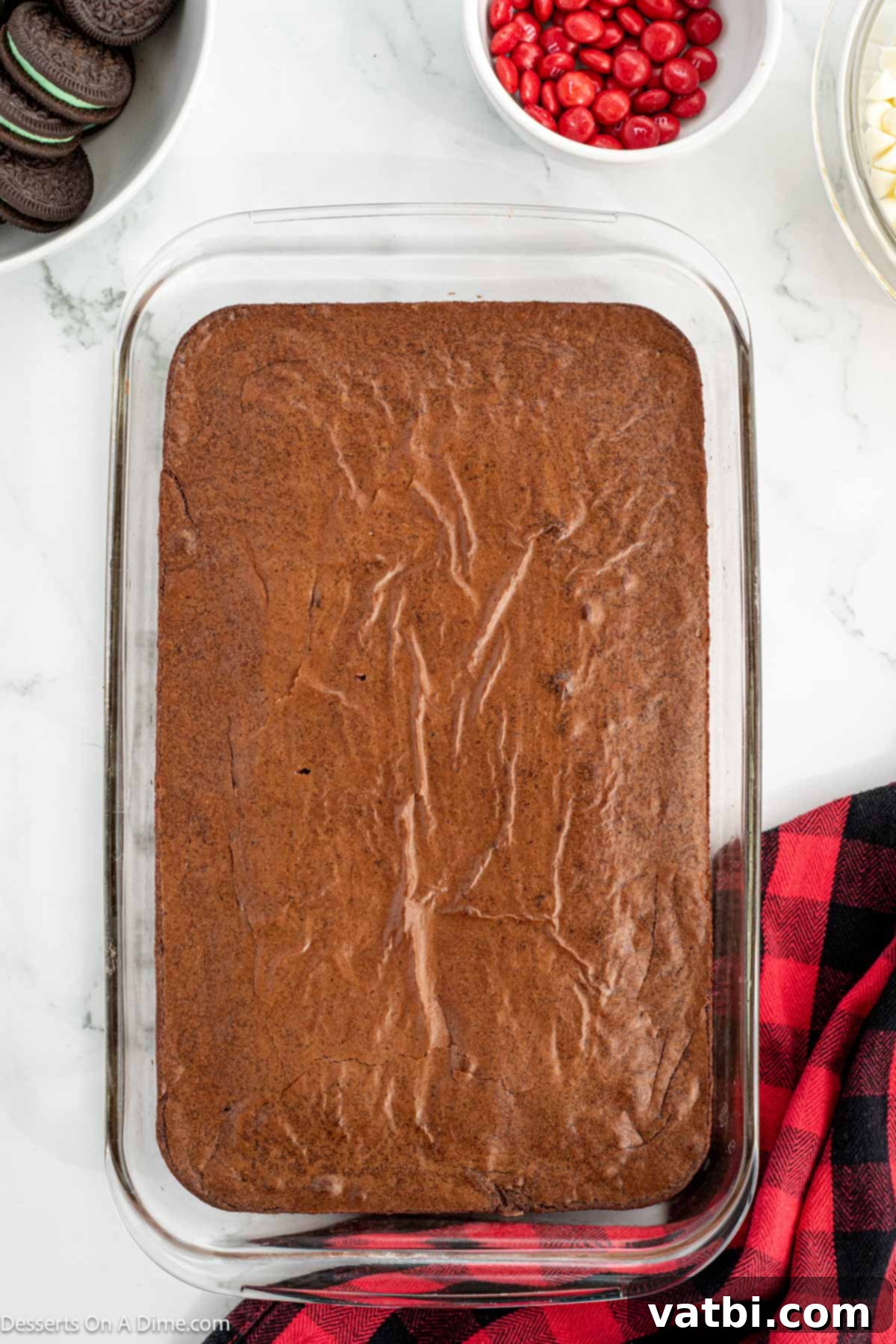 Grinch's Festive Fudgies 6 Baked brownies in a pan, cooled and ready for topping.
