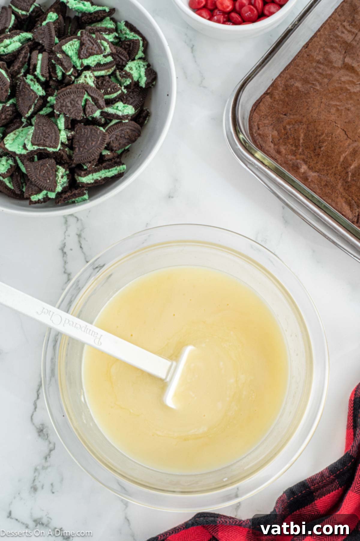 Grinch's Festive Fudgies 7 White chocolate chips and heavy cream in a heat-safe bowl, ready for melting.