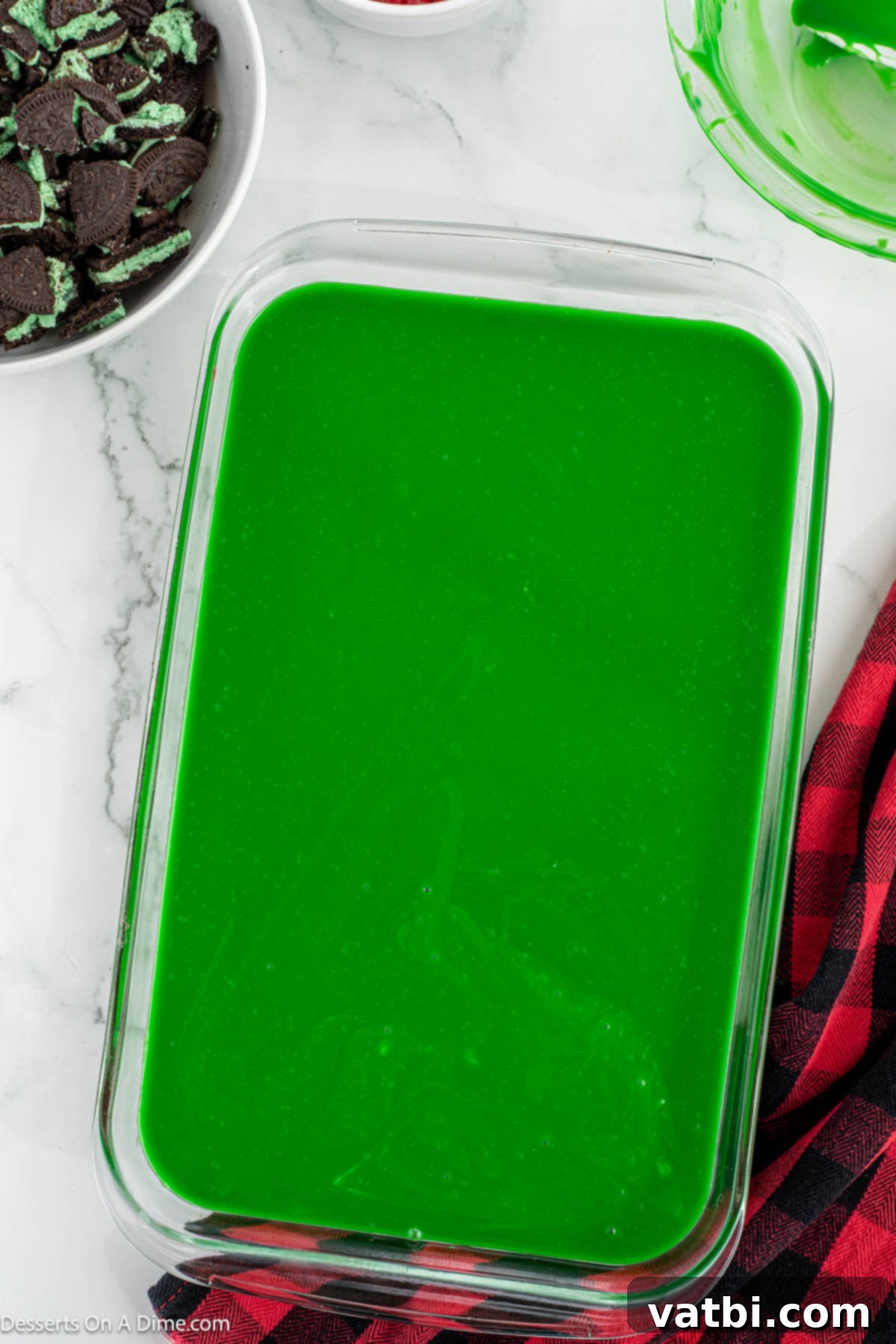 Grinch's Festive Fudgies 9 Vibrant green ganache spread smoothly over the cooled brownies in the pan.