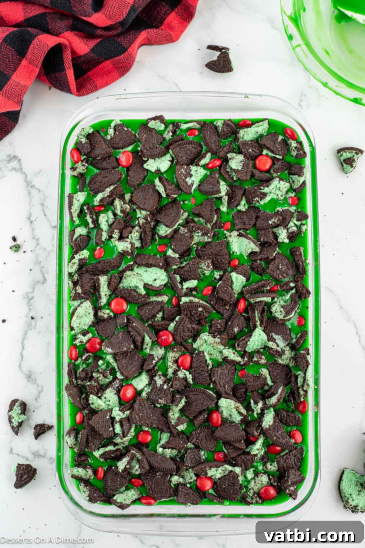 Grinch's Festive Fudgies 10 Chopped Mint Oreos and red M&Ms sprinkled generously on top of the green brownies.