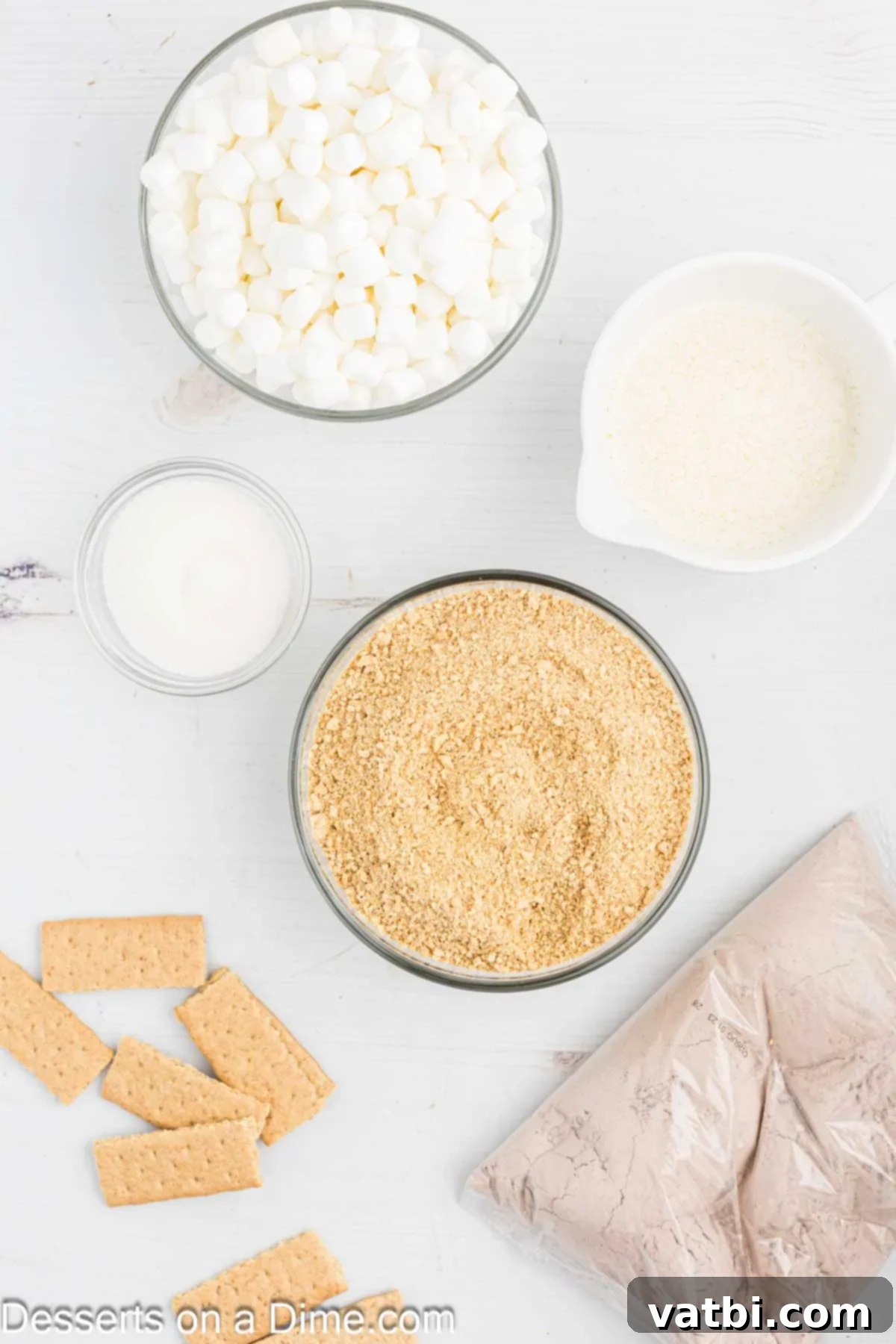Gooey S'mores Brownie Bliss 3 All the essential ingredients for making S'mores brownies laid out: graham cracker crumbs, melted butter, a boxed brownie mix, mini marshmallows, and extra graham crackers for topping.