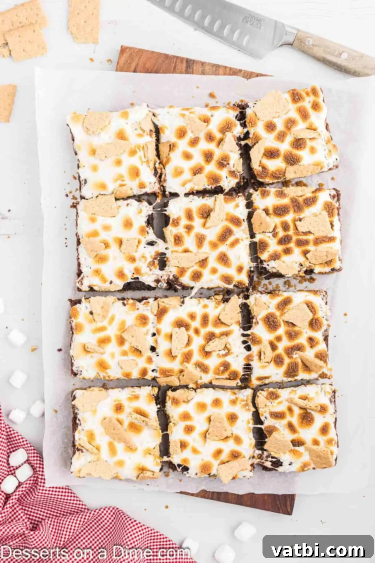 Gooey S'mores Brownie Bliss 10 Perfectly cut S'mores brownies arranged for serving, showing off their distinct layers and golden marshmallow topping.