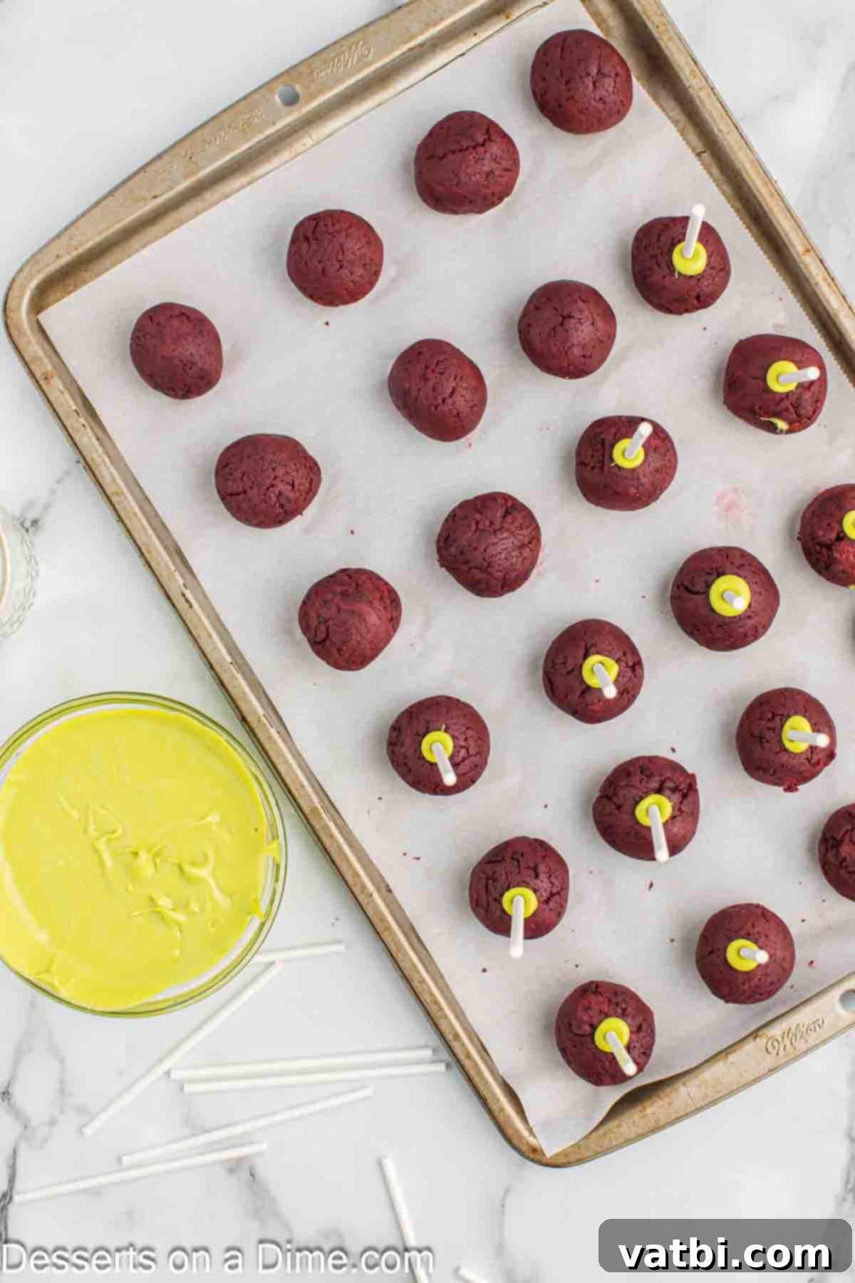 Whoville Grinch Cake Pops 8 Dipping cake pop sticks into melted green candy.
