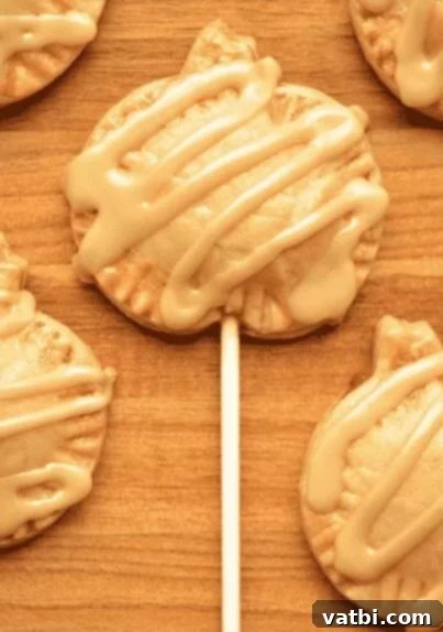 35 Thanksgiving Treats Kids Will Gobble Up 5 Mini Pumpkin Pie Pops on a stick, drizzled with icing.