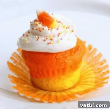 35 Thanksgiving Treats Kids Will Gobble Up 6 Candy Corn Cupcakes, with distinctive layered colors and frosting.