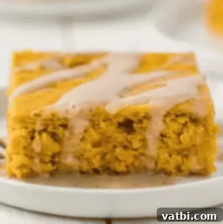 35 Thanksgiving Treats Kids Will Gobble Up 14 Pumpkin Cake, slice served on a plate with whipped cream.