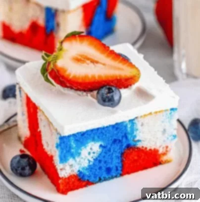 A slice of Tie-Dye 4th of July Cake with swirled red, white, and blue colors.