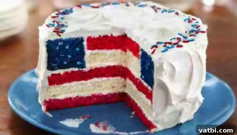 A slice of Red, White and Blue Layered Flag Cake with colorful layers.