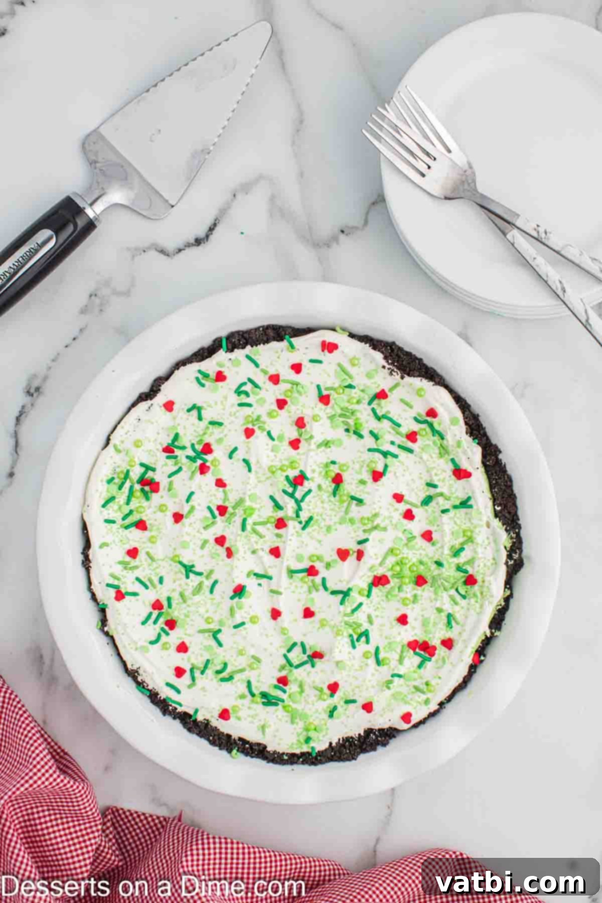 The Grinch's Heart-Melting Holiday Pie 11 The fully prepared Grinch Pie in a pie plate, garnished with festive sprinkles, ready for chilling