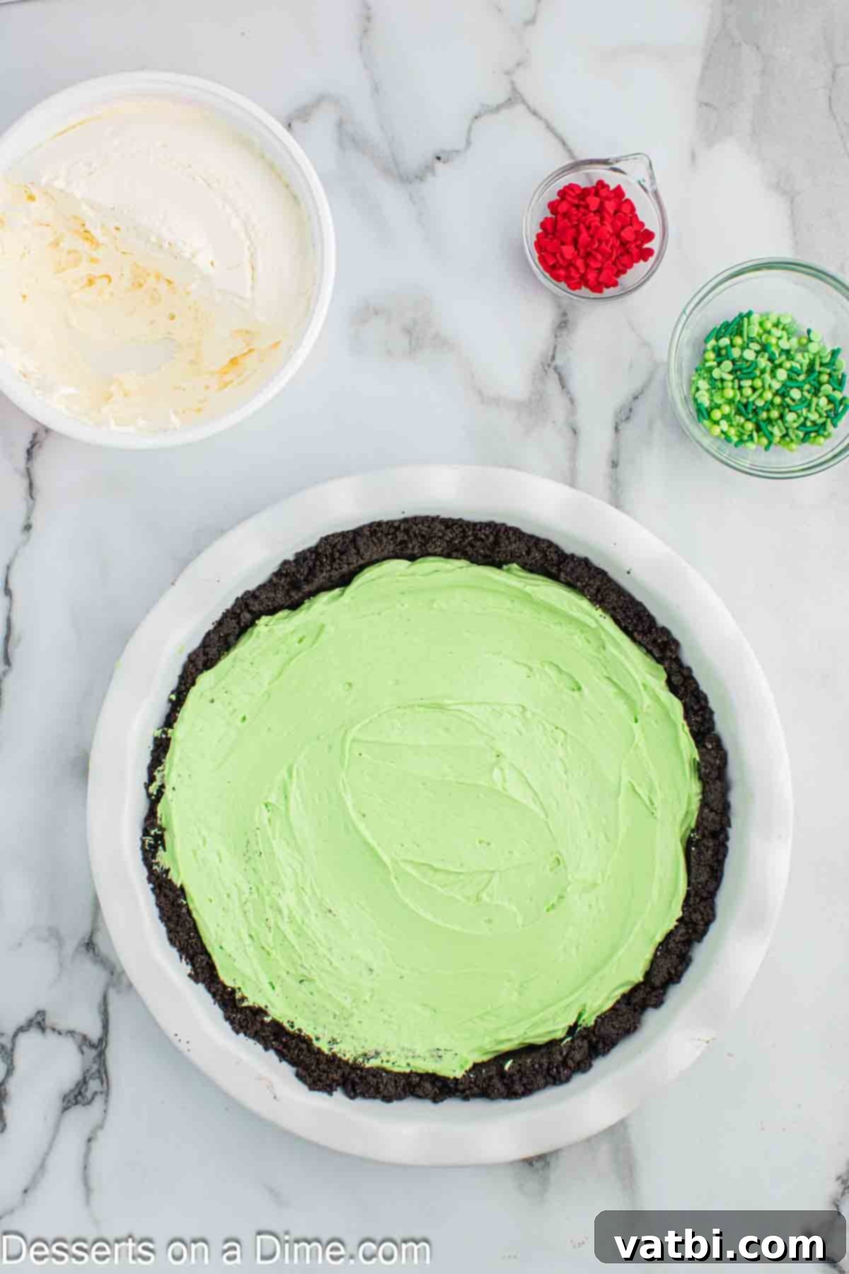 The Grinch's Heart-Melting Holiday Pie 9 Spreading the green pie filling evenly into the chilled Oreo crust