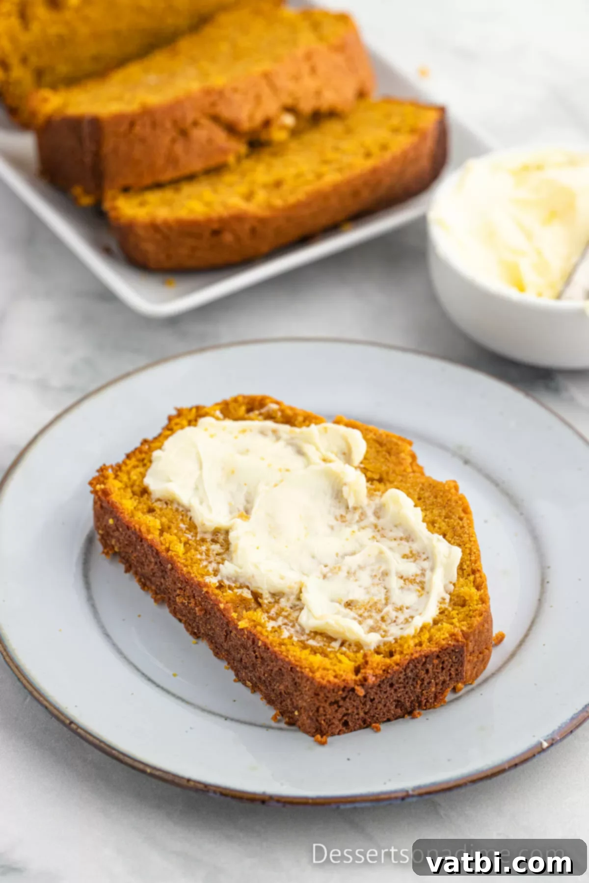 Libby's Pumpkin Bread Recipe 9 A slice of Libby's pumpkin bread with a pat of butter melting on top, ready to be enjoyed.