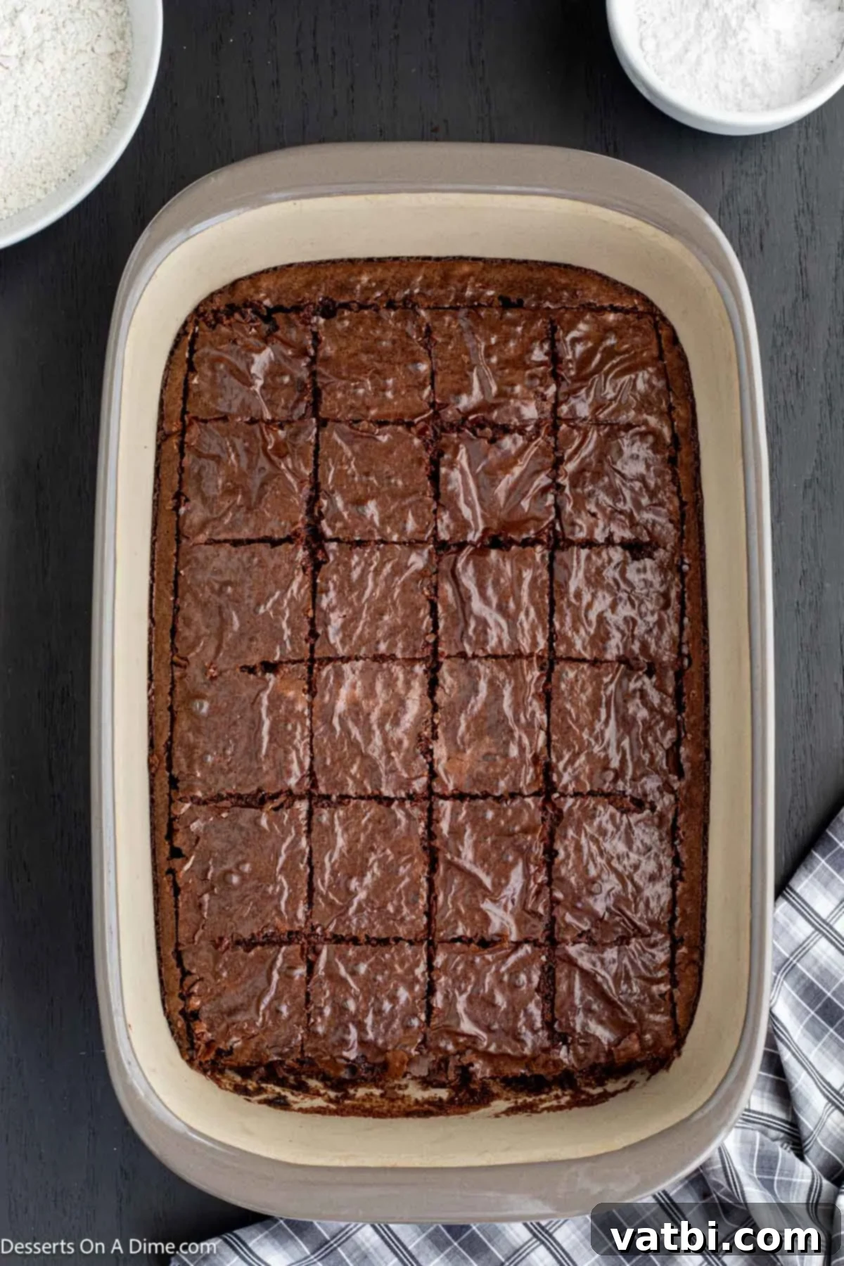 Decadent Deep-Fried Brownies 5 Cooled brownies cut into uniform squares on a cutting board.
