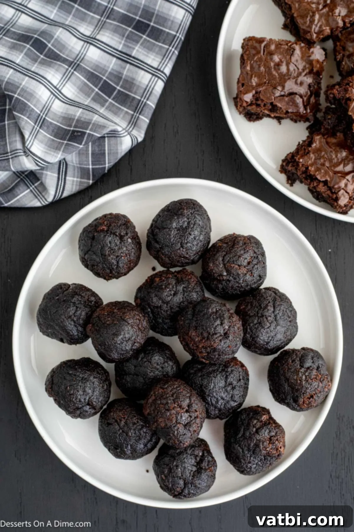 Decadent Deep-Fried Brownies 6 Brownie pieces rolled into smooth balls, arranged on a plate.