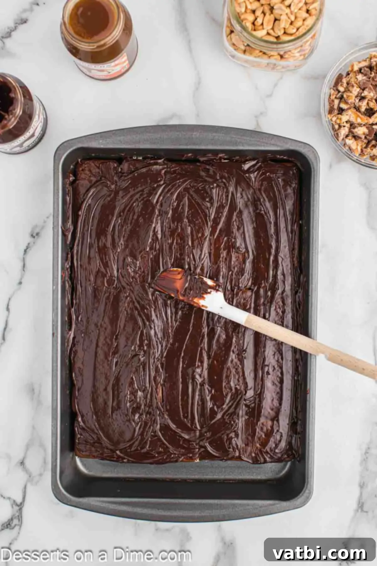 Decadent Snickers Ice Cream Cake 5 Hot fudge spread on top.