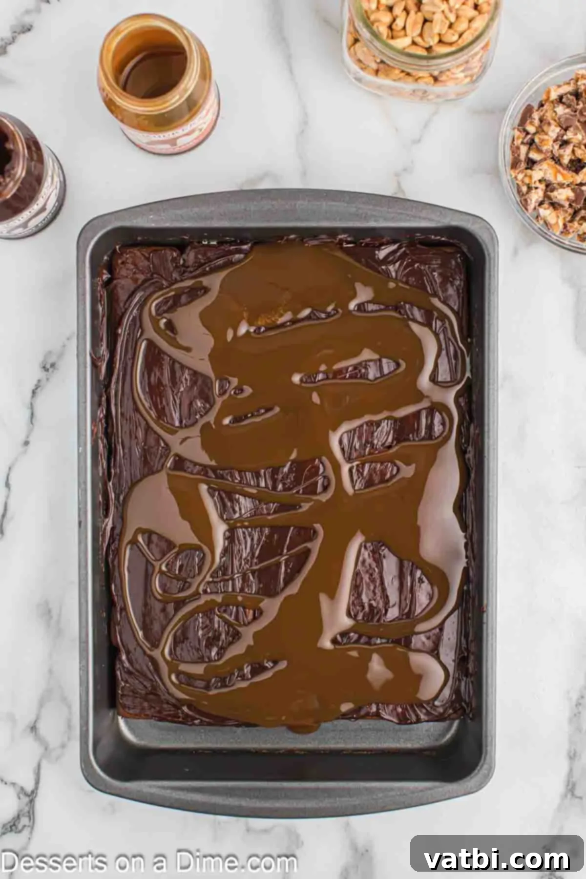 Decadent Snickers Ice Cream Cake 6 Spead caramel sauce on top.