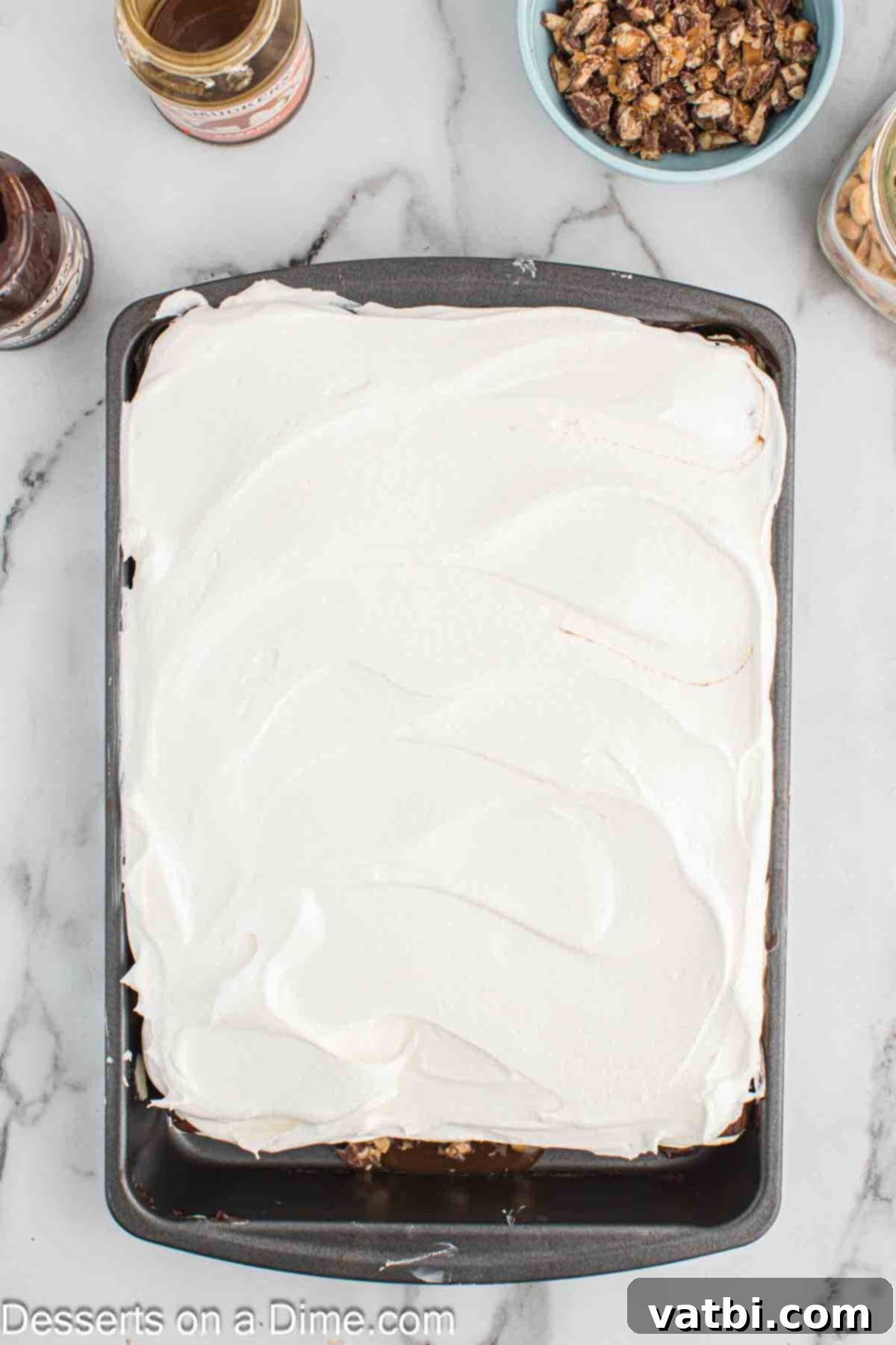 Decadent Snickers Ice Cream Cake 9 Whipped cream layered on top.
