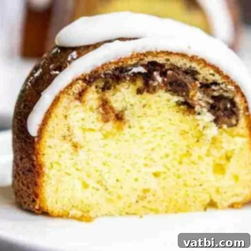 31 Sweet Texas Delights 11 A beautifully glazed Sock It To Me Cake, showcasing its pecan and cinnamon swirl, ready to be sliced.
