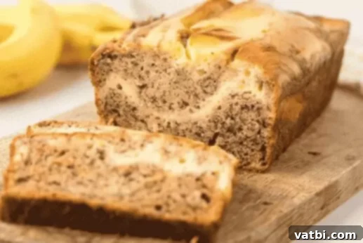 37 Must-Try Brunch Desserts 8 Slice of cream cheese banana bread with a swirl.