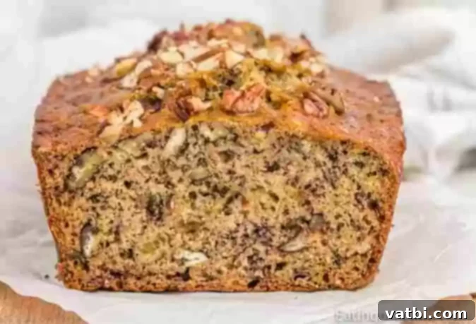 37 Must-Try Brunch Desserts 9 Slice of banana pecan bread on a white plate.