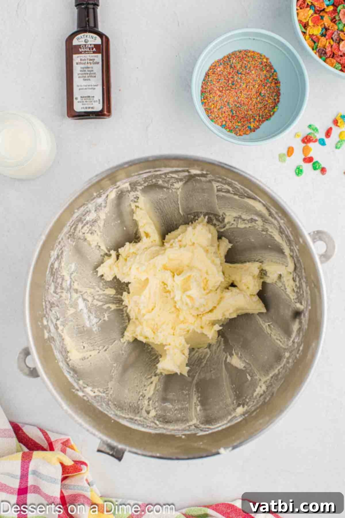 Rainbow Cereal Cupcakes 7 Softened butter and powdered sugar in a mixing bowl, beginning to be combined for frosting.