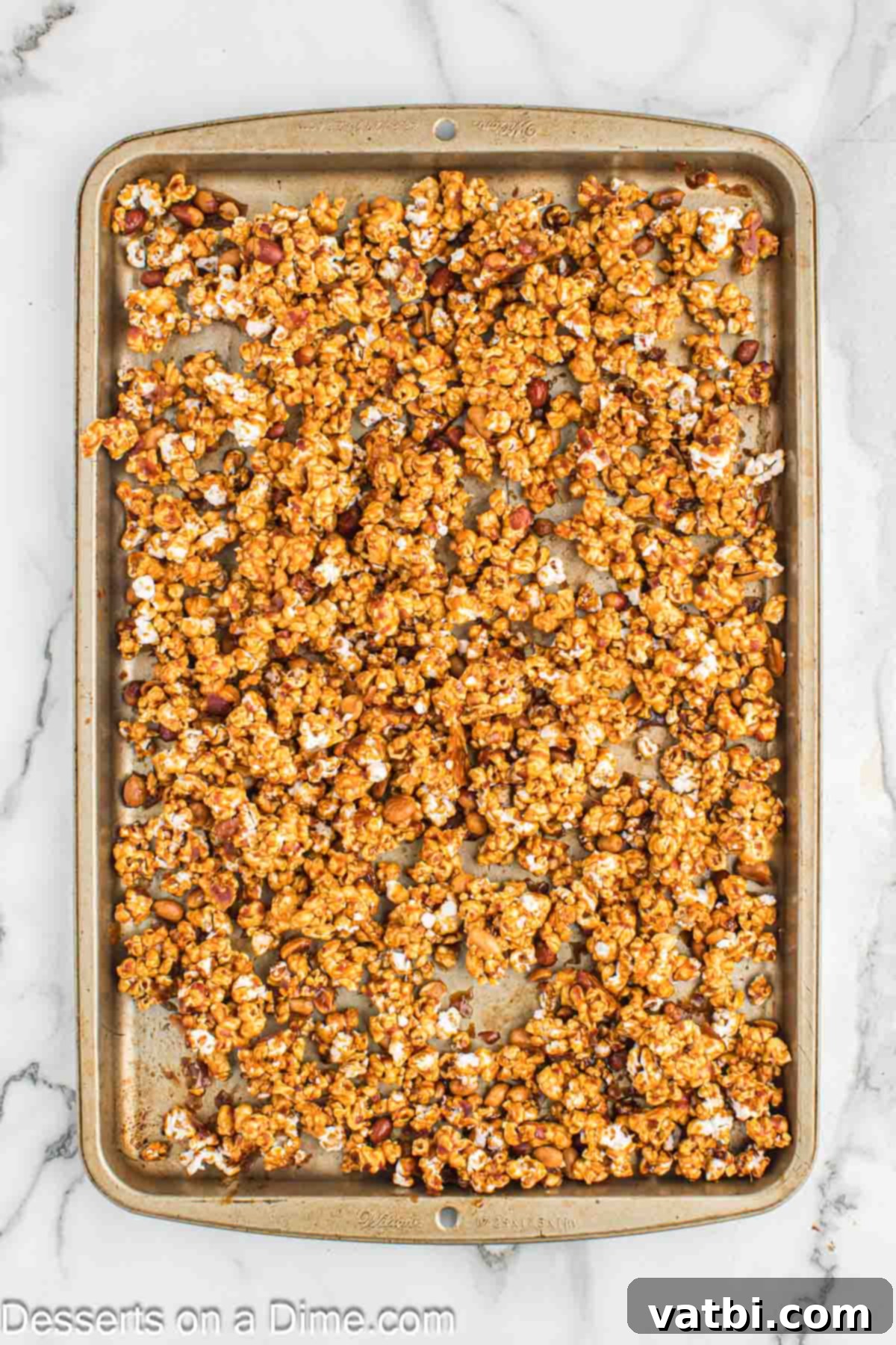 Homemade Cracker Jacks 9 Caramel popcorn spread on baking sheets.