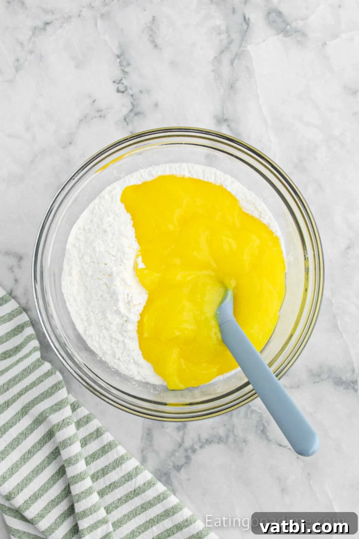 Sunshine Lemon Angel Food Cake 4 Cake mix combined with lemon pie filling in a bowl.