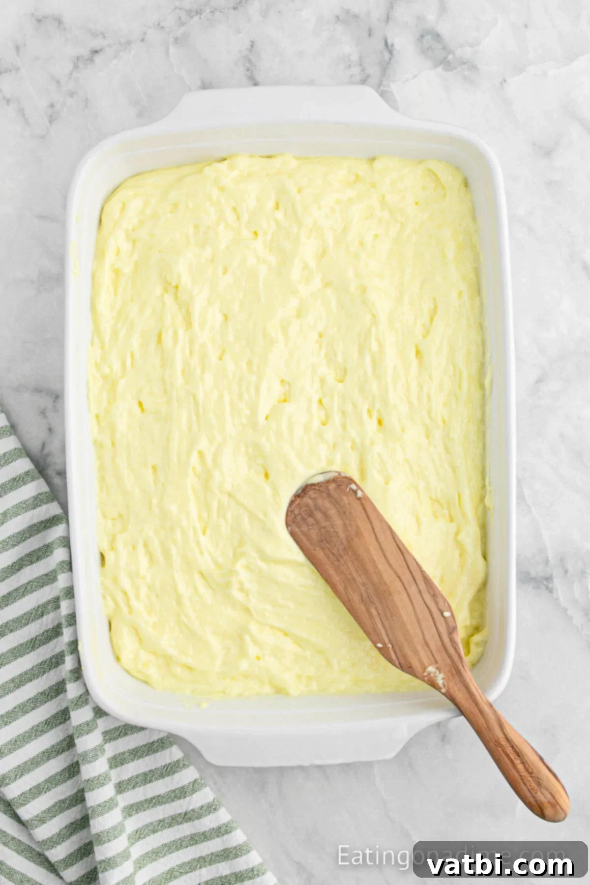 Sunshine Lemon Angel Food Cake 5 Batter spread into baking dish.