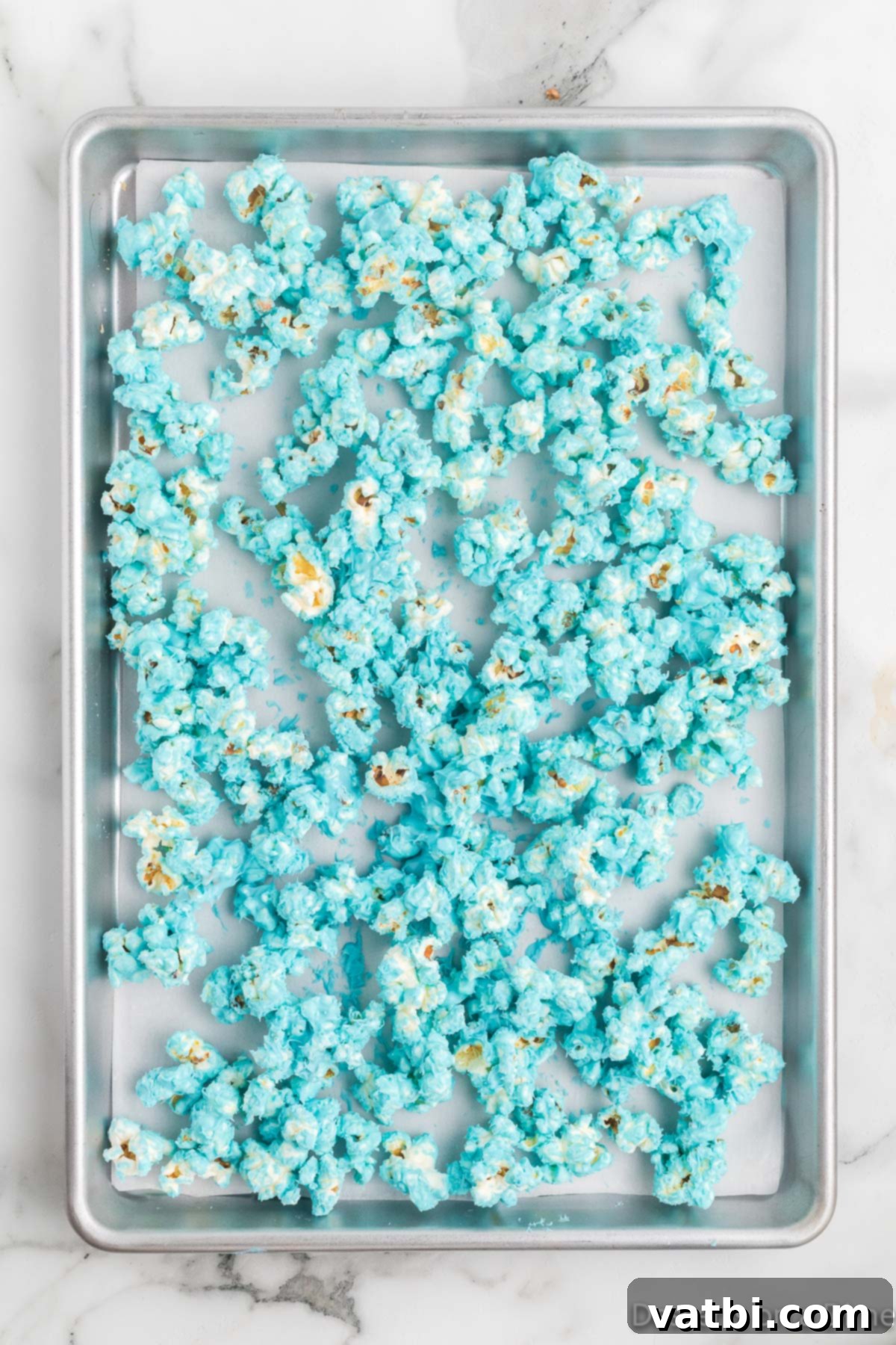 Cloud Nine Crunch 10 Blue popcorn on baking sheet.