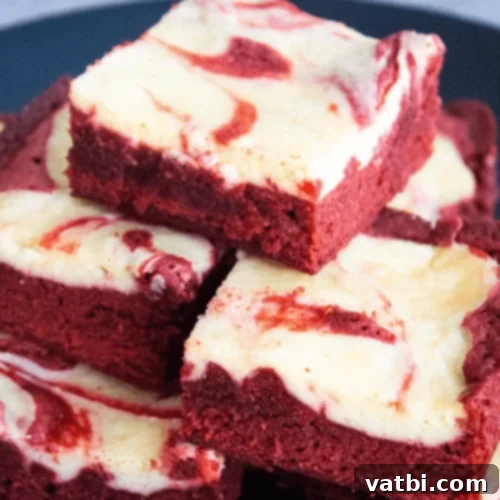 29 Decadent Red Velvet Desserts 3 Red Velvet Cheesecake Bars with a swirled pattern.