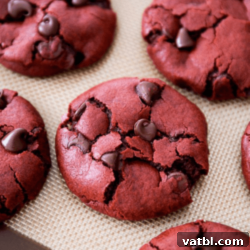 29 Decadent Red Velvet Desserts 5 Red Velvet Chocolate Chip Cookies on a cooling rack.