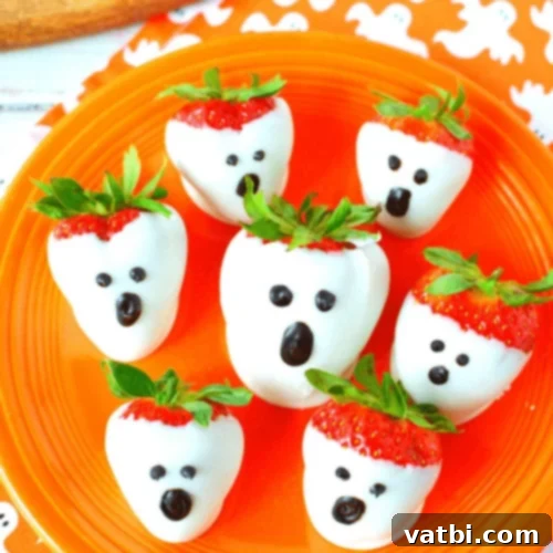 Strawberry Halloween Ghosts, fresh strawberries dipped in white chocolate and decorated.