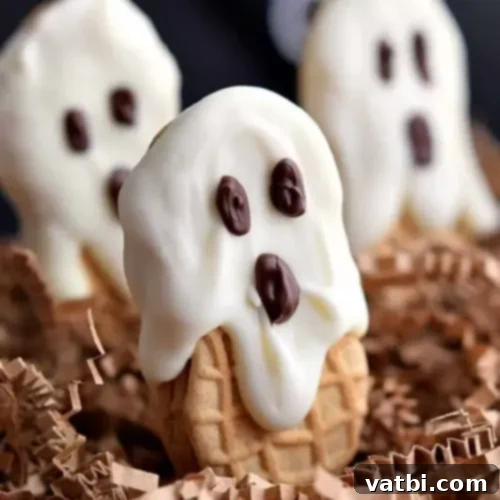 Nutter Butter Ghost Cookies, dipped in white chocolate with chocolate chip eyes.
