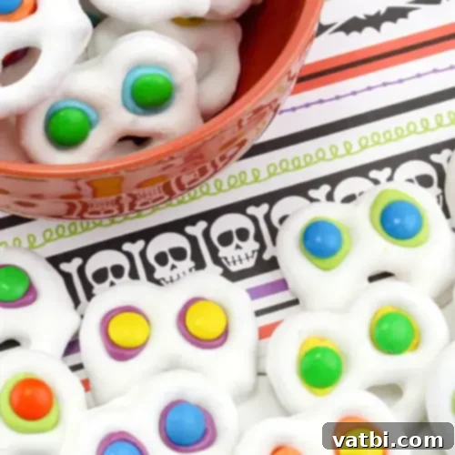Screaming Ghost Pretzel Candy, decorated with white chocolate and candy eyes.