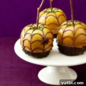 Halloween Spiderweb Caramel Apples with a chocolate spiderweb design.