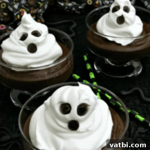 Halloween Whipped Cream Ghosts, piped into ghost shapes with chocolate chip eyes.