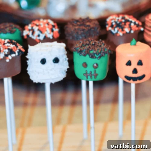 Halloween Marshmallow Pops decorated as mummies, ghosts, and Frankenstein monsters.