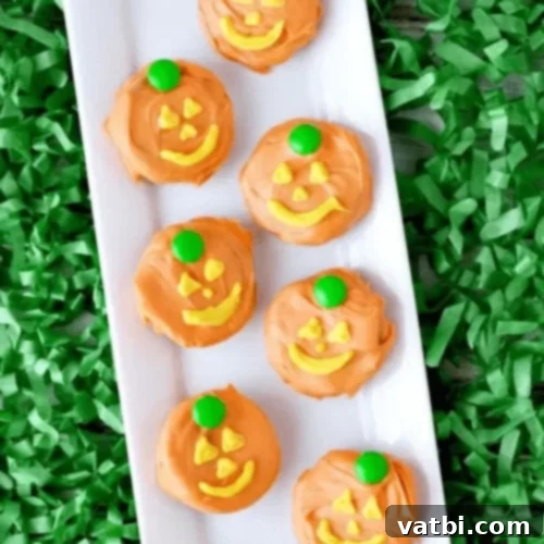 Jack-O-Lantern Chocolate Covered Oreos with festive faces.