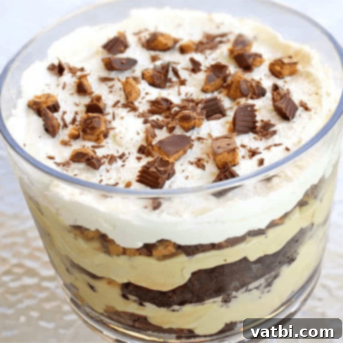 Peanut Butter Cup Trifle, a decadent no-bake dessert with layers of peanut butter and whipped cream.