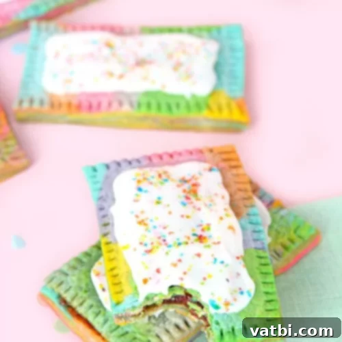 37 Magical Unicorn Desserts 21 Rainbow Marbled Pop Tarts with strawberry filling, vanilla icing, and sprinkles.